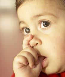 stock photo of a young child sucking its thumb